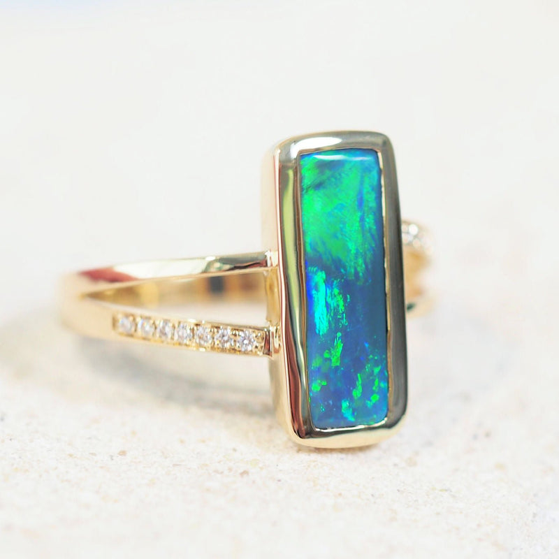 gold black opal ring with a green and blue australian opal with diamonds