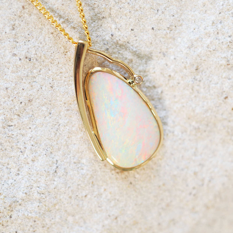Colourful white opal pendant set in gold