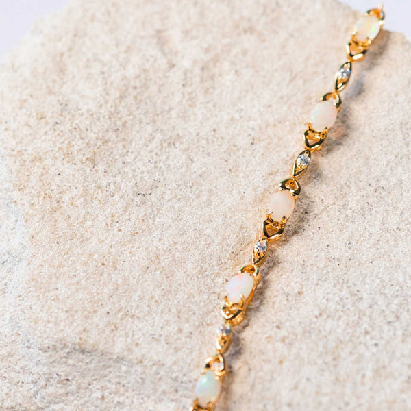 white opal bracelet set in a passion design gold plated silver setting