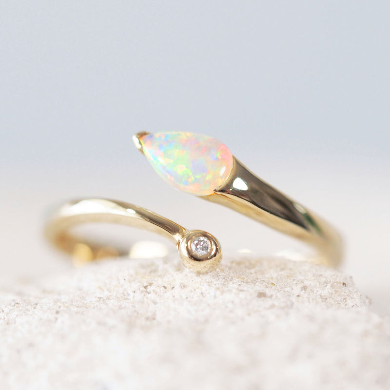 teardrop shape colourful crystal opal ring in 14ct gold with one sparkling diamond