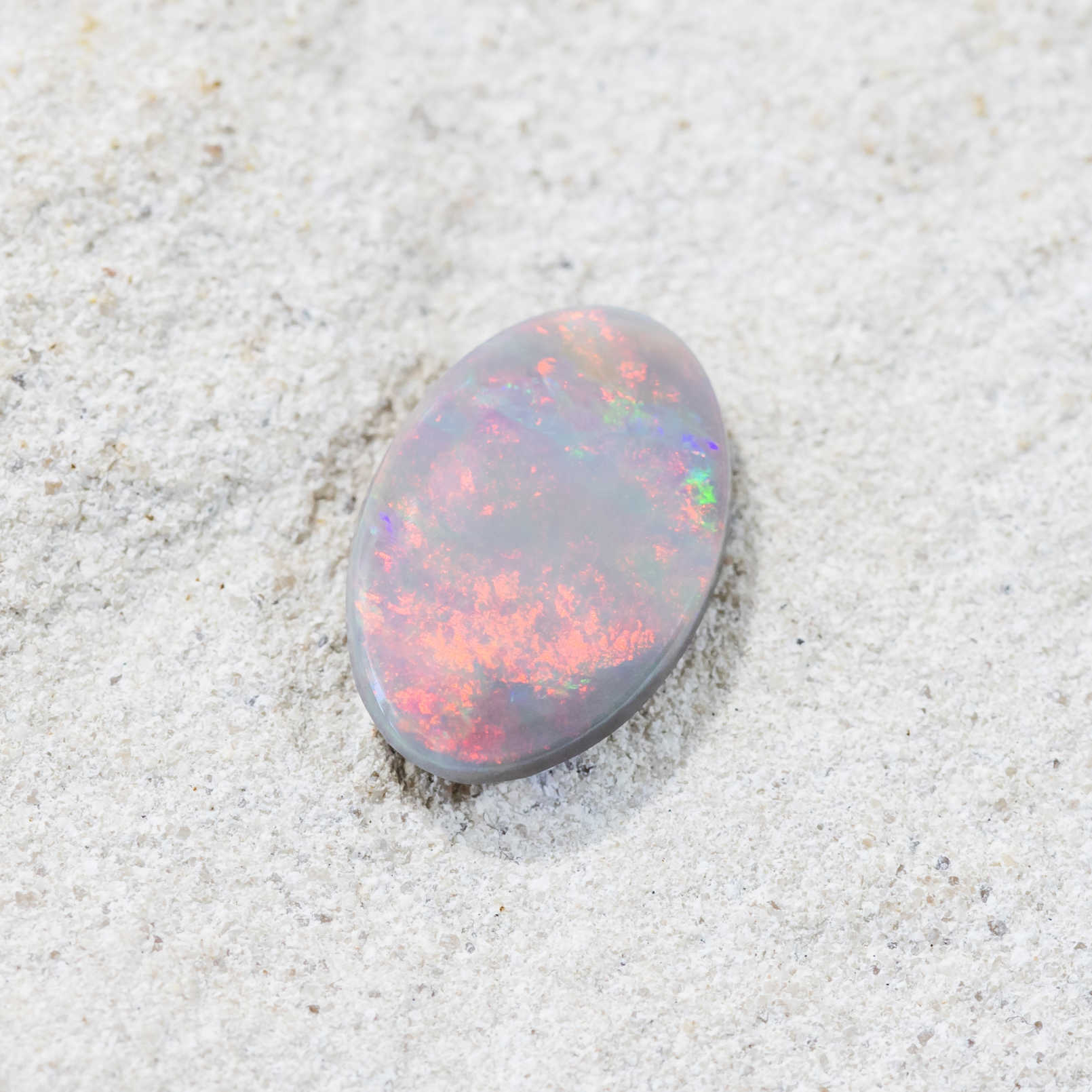 Close-up of Rainbow Cloud solid opal with swirling multicolour brilliance