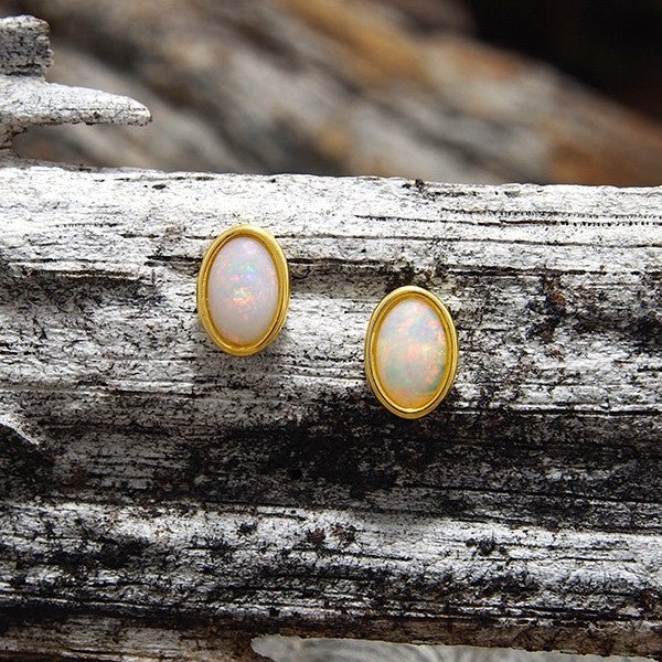 Modern gold plated sterling silver stud earrings bezel set with oval multi-colour South Australian crystal opals with pink highlights.