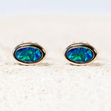 Classic sterling silver stud earrings bezel set with blue and green-coloured oval Australian triplet opals.