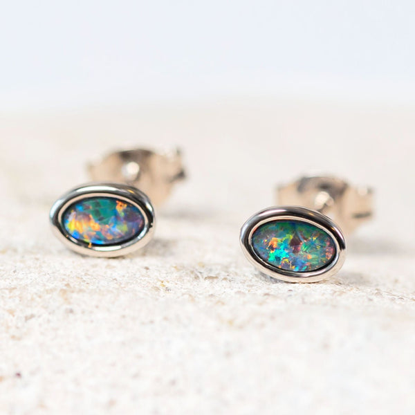Classic sterling silver stud earrings bezel set with multi-coloured oval Australian triplet opals.