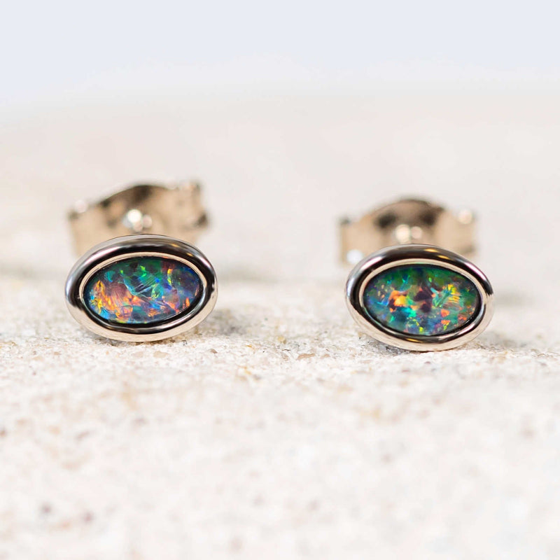 Classic sterling silver stud earrings bezel set with multi-coloured oval Australian triplet opals.