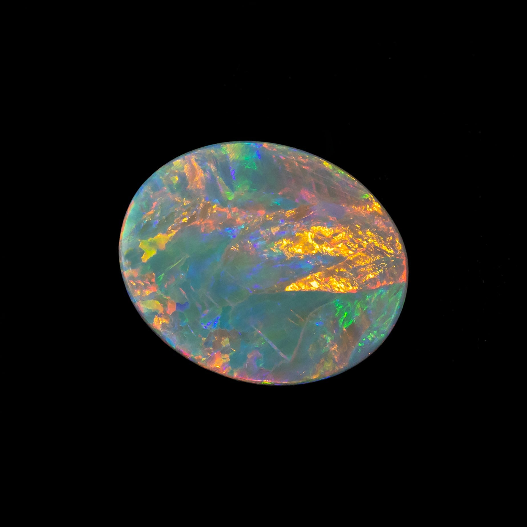 Star of the Outback opal showing vivid multi-colour flagstone pattern with a light grey body tone.